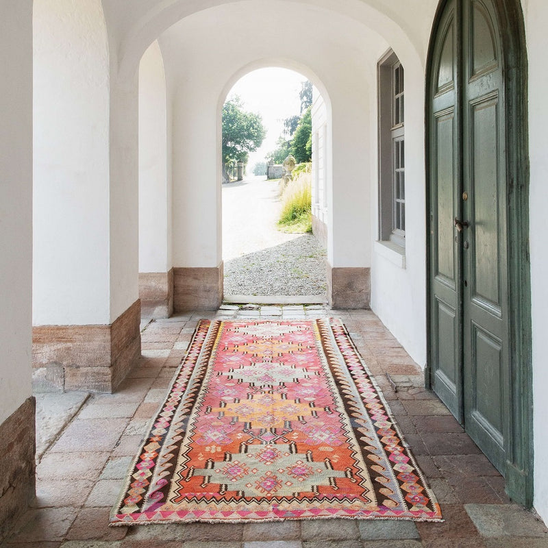 Mutte Storm kilim in a passage with green door